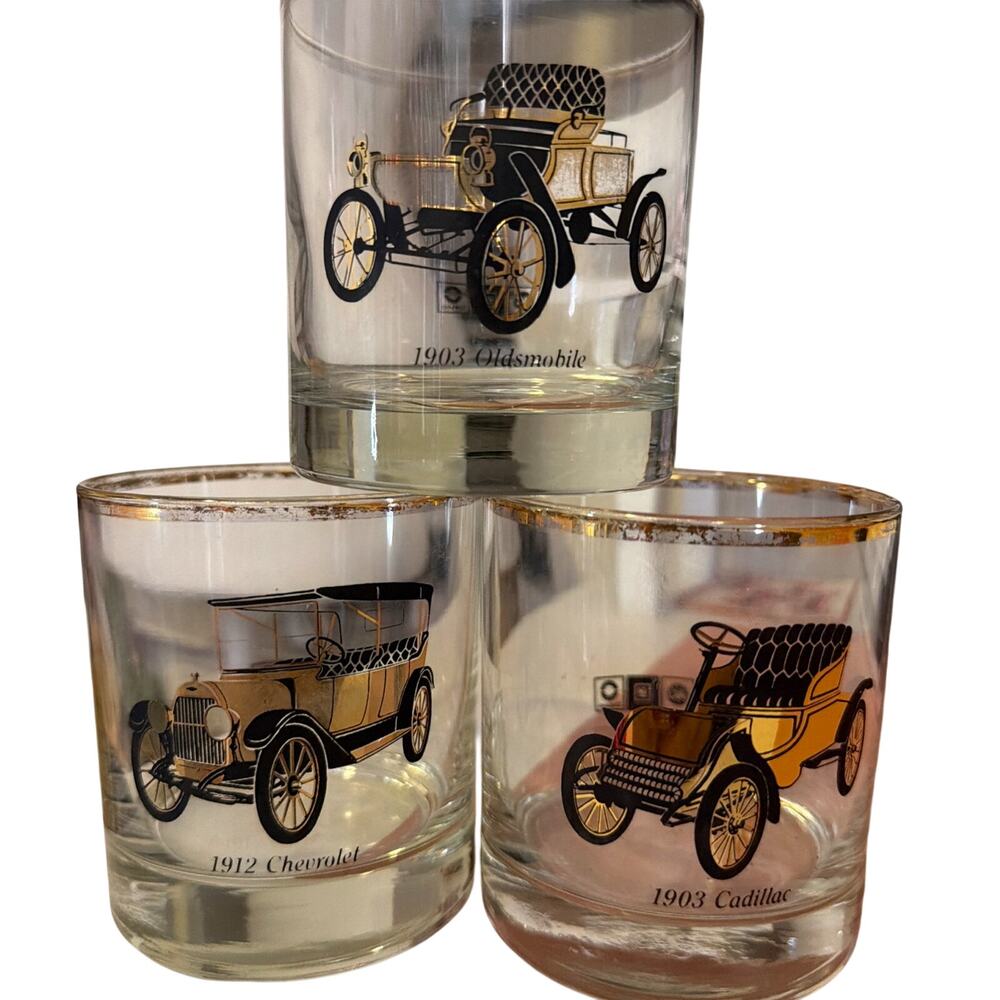 These are gold-rimmed glassware cocktail glasses featuring antique cars